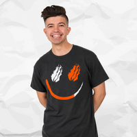 Preston Stylez wearing a drak gray t-shirt with a graphic of white and orange flames forming a smiley face, set against a light gray crumpled paper background.